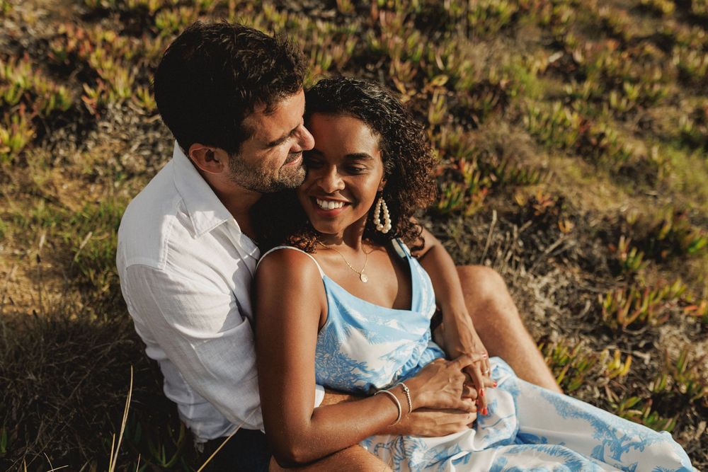 Close up of happy couple embracing during engagement session at Praia das Bicas Sesimbra Portugal
