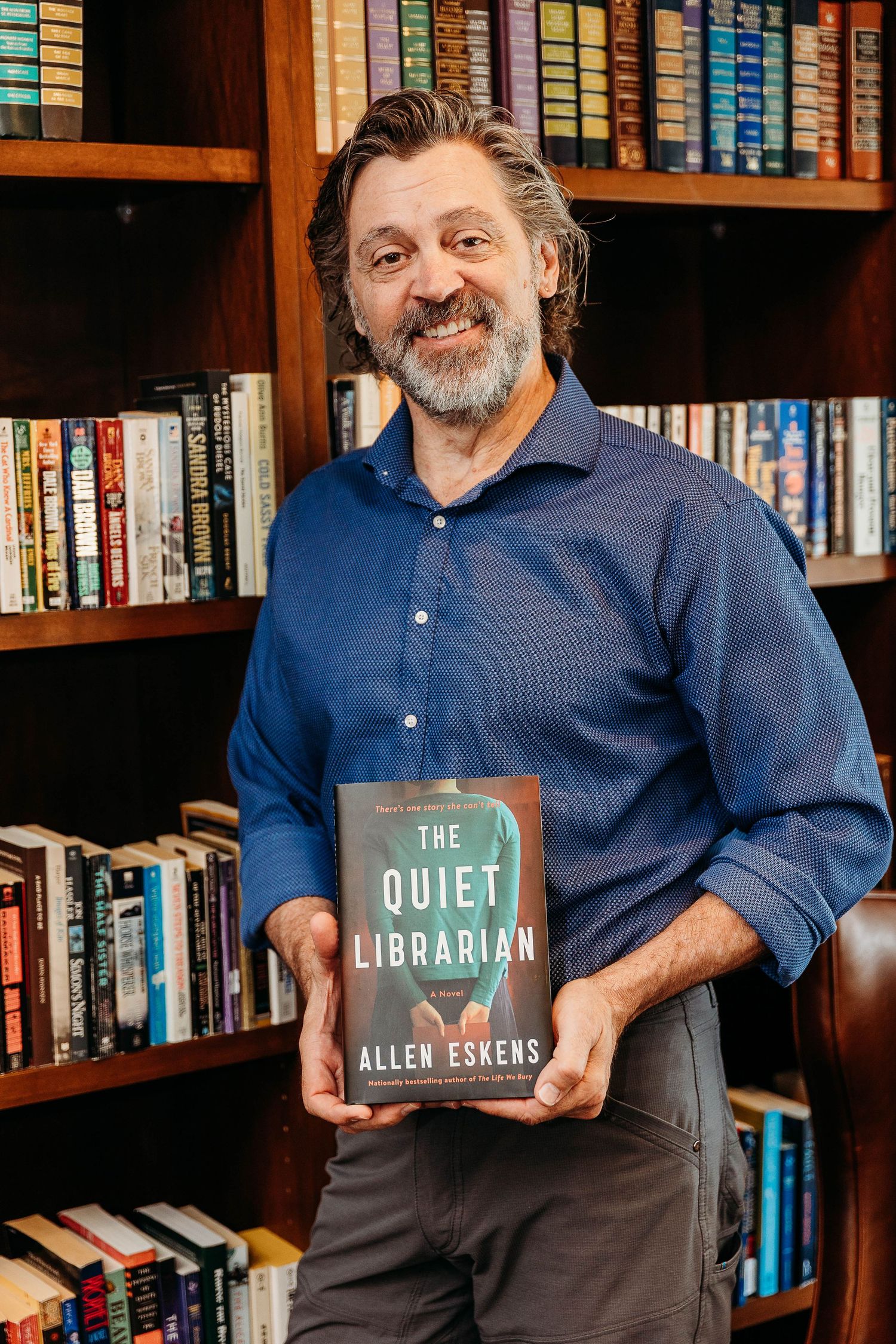 A series of photos showing someone in a blue shirt posing with various books against a bookshelf background.