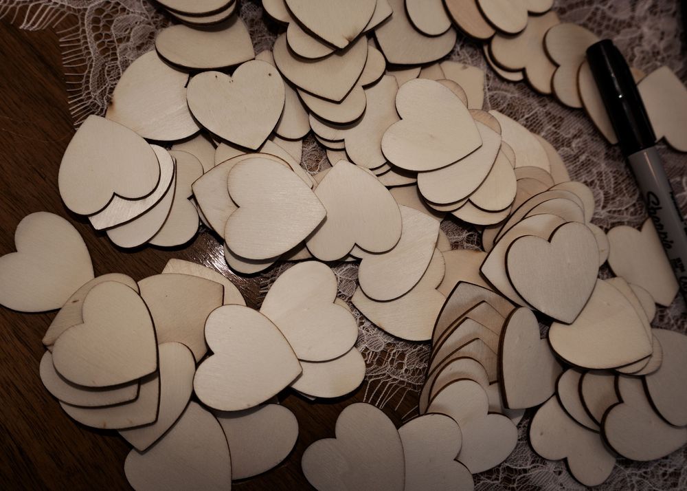 Romantic heart-shaped paper decorations in sepia tones create an elegant vintage pattern background.