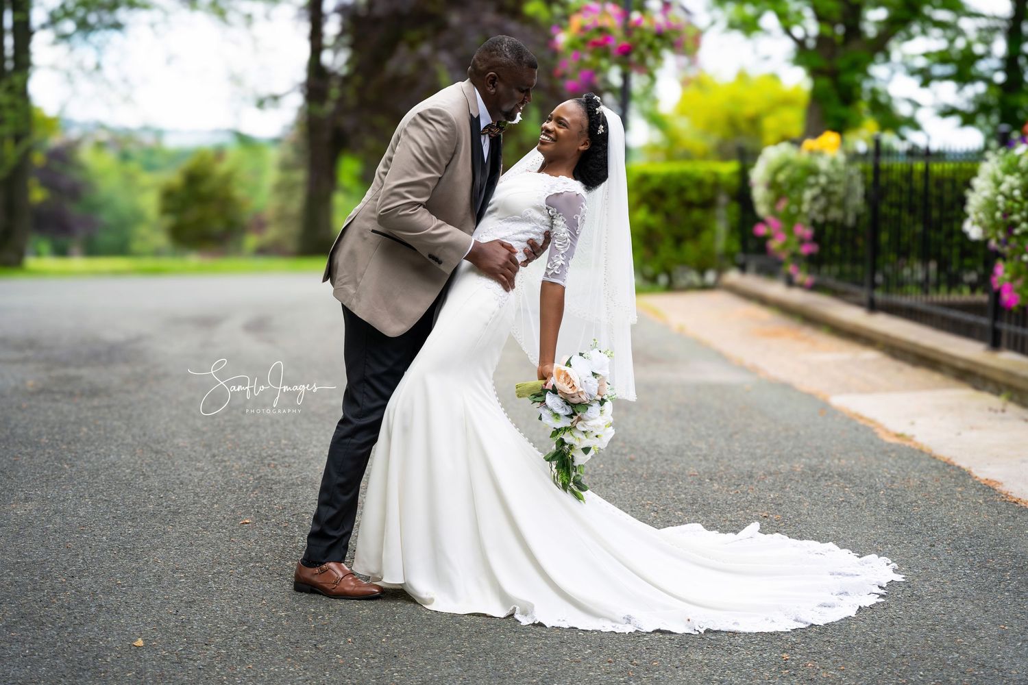 A romantic wedding couple shares intimate moments in a garden setting during their outdoor photo session.