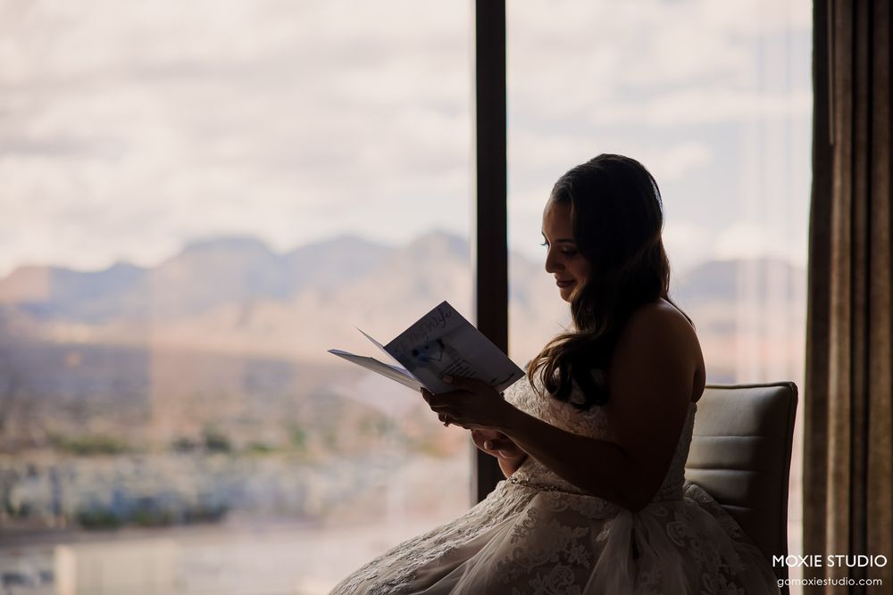 Silhouettes of people looking out large windows with mountain views.
