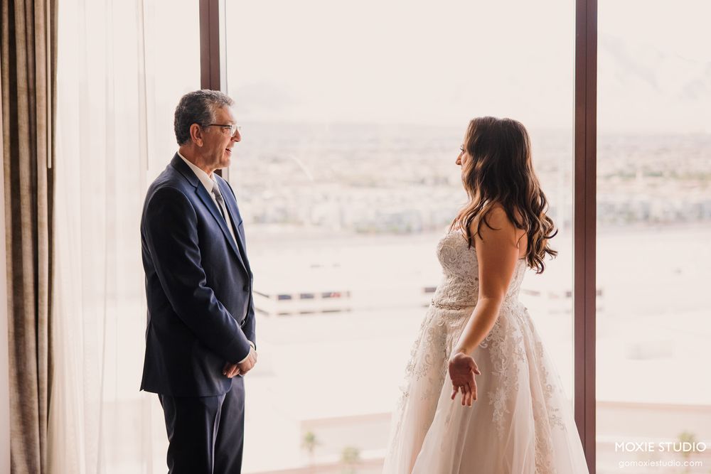 Emotional first look moment between couple with scenic desert mountain backdrop.