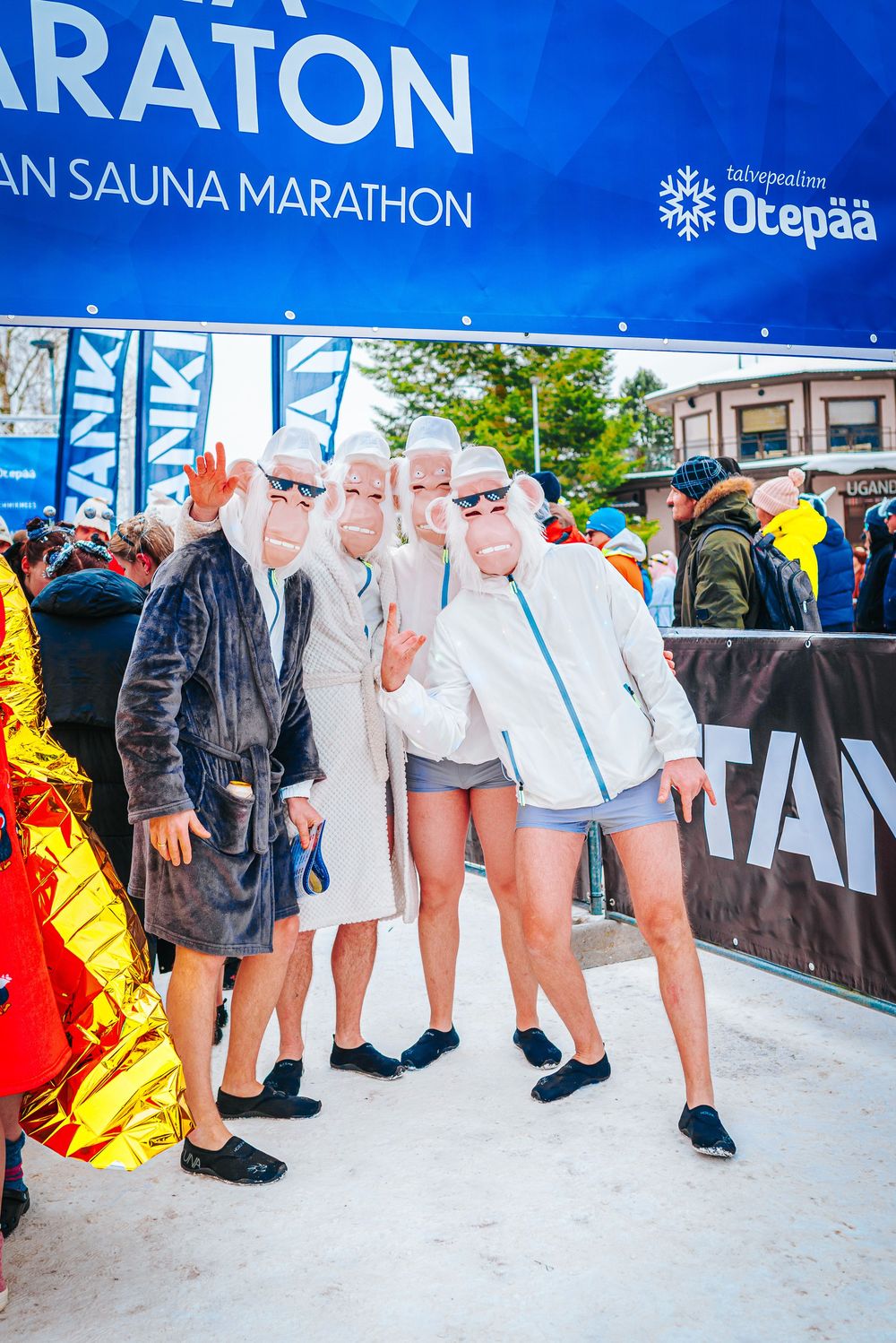 Participants pose at the Finnish Sauna Marathon event under a blue banner with Otepaa branding.