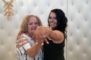 Two people share a joyful moment together during what appears to be a celebration or special event.