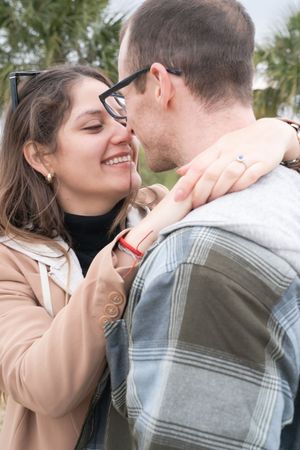 An intimate moment captured between a couple near Charleston's iconic bridge.