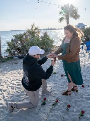 A sequence of photos showing someone playing bocce ball on a sandy beach with palm trees and ocean views at sunset.