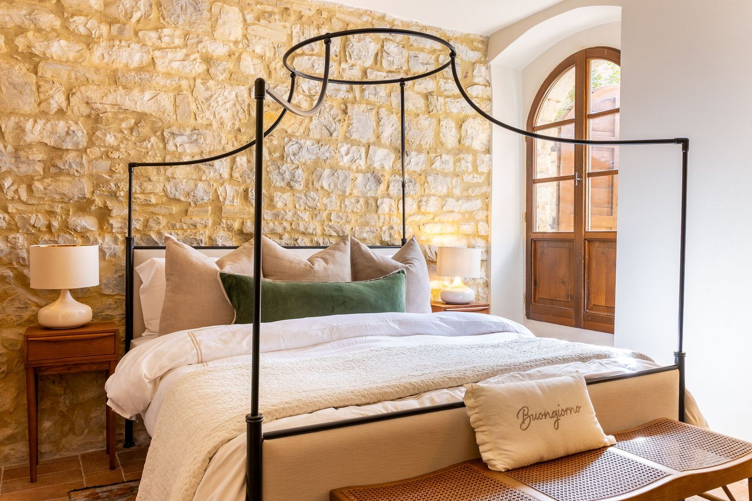 Tuscany commercial property photographer. Rustic Mediterranean bedroom with canopy bed frame.