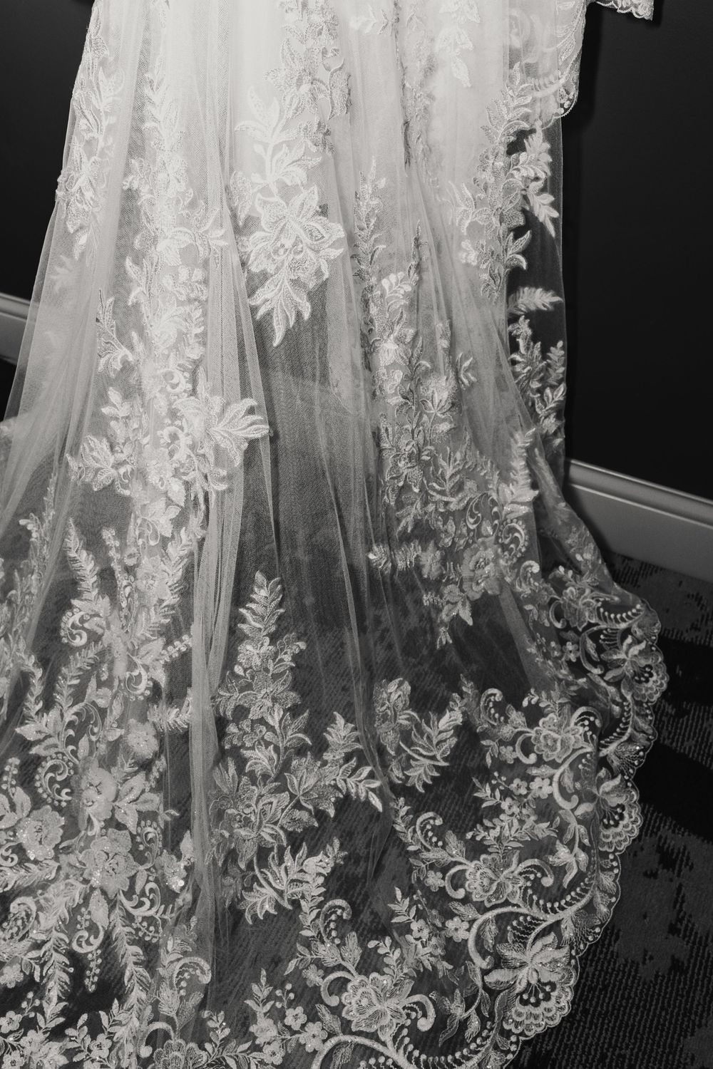 Intricate lace details and floral embroidery on a white wedding dress in black and white at winter wedding at Yorktowne Hotel in York, PA