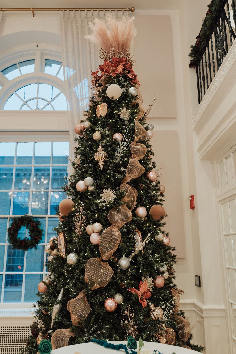 Elegant Christmas trees decorated with white ornaments and burlap ribbons for winter wedding at Yorktowne Hotel in York PA