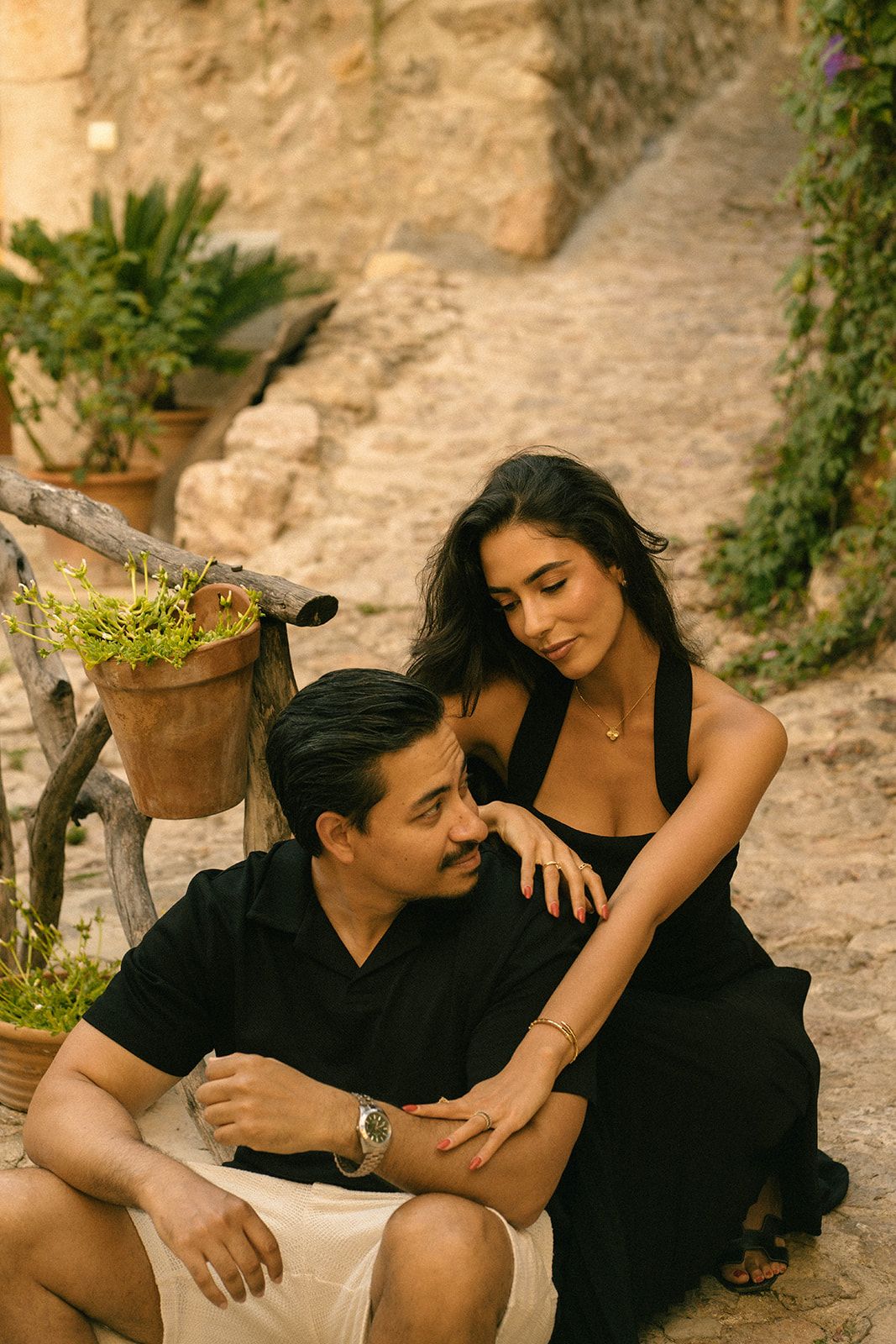 couple sitting together in Valldemossa, being photographed