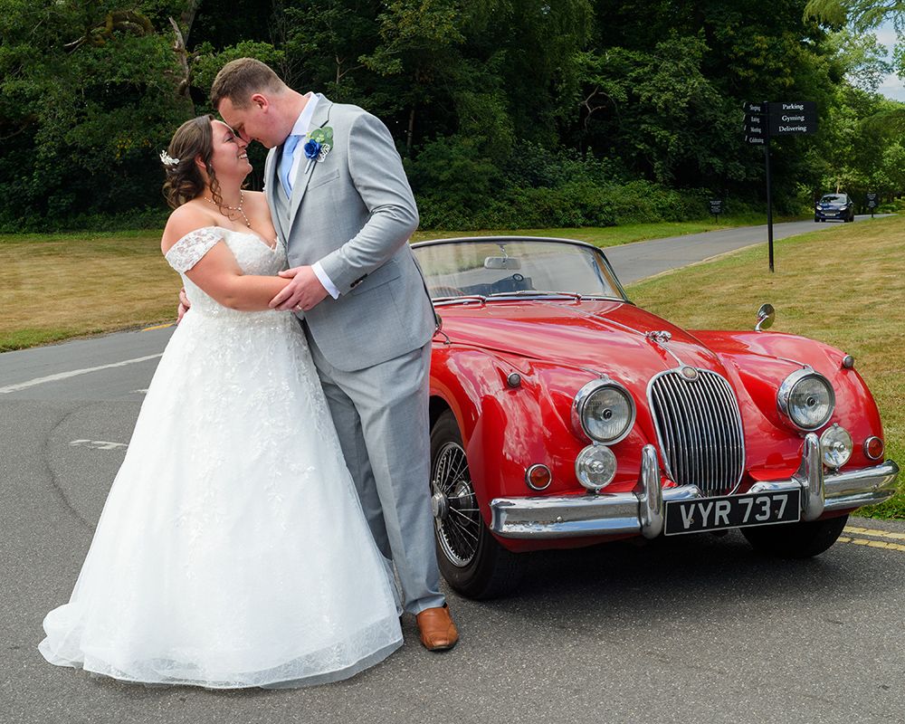 A bride and groom share a kiss, capturing a romantic moment in their wedding photography by Abigail's Studio in High Wycombe.