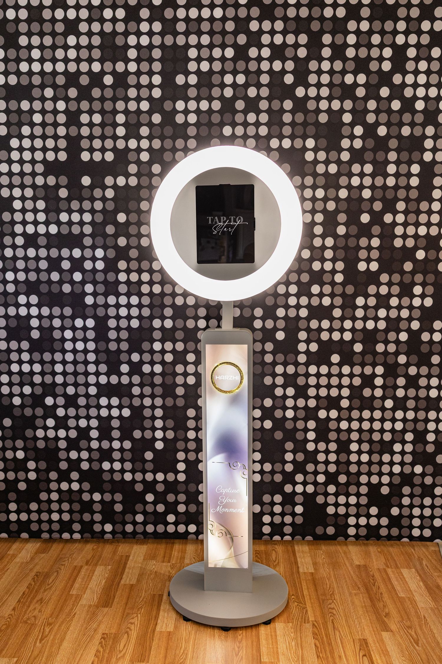 Five identical white circular LED vanity mirrors with illuminated rings displayed on wooden floor against dotted wall pattern.
