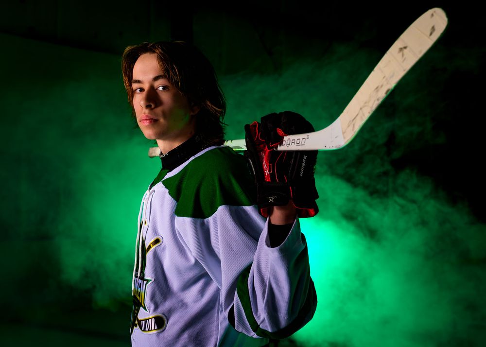 Close-up portrait of a Keystone Kraken hockey player in helmet and uniform, set against a green foggy background.