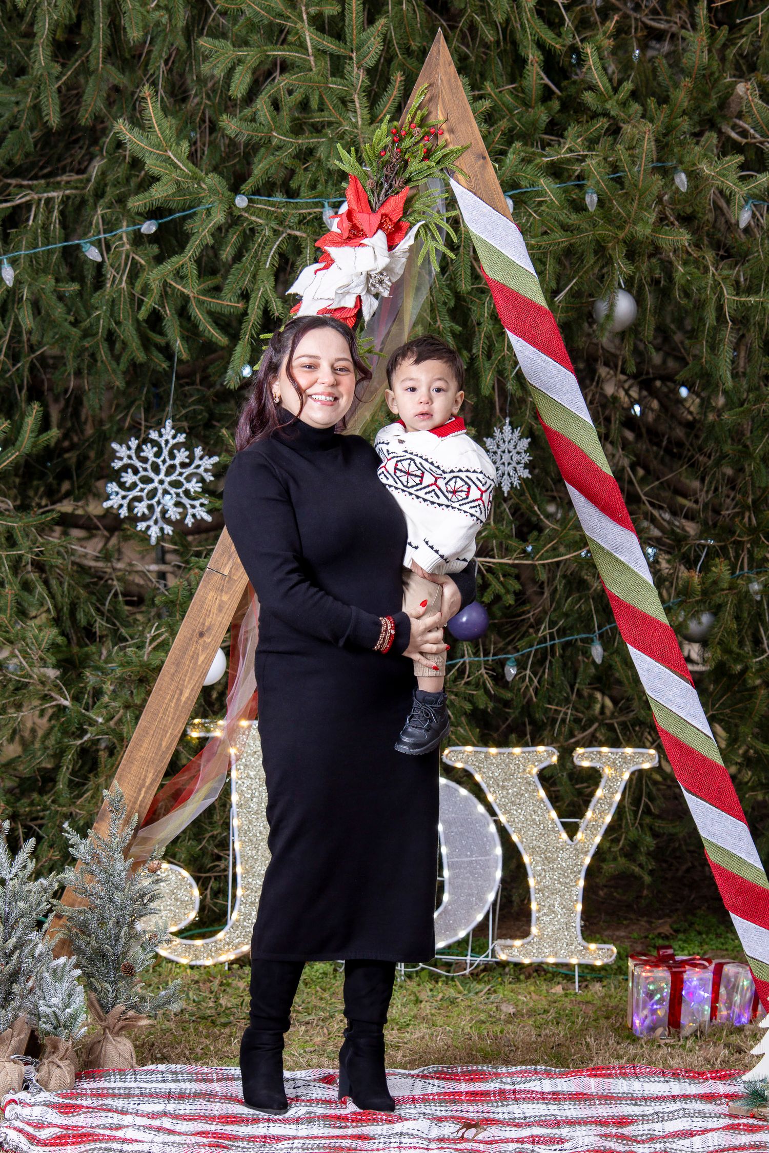 Festive family portraits in Elkins, Arkansas, captured outdoors on a cold day, highlighting connection, laughter, and the anticipation of a