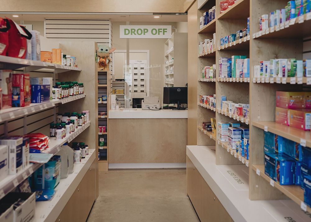 A well-organized laundry room with folding tables and shelves stocked with cleaning supplies and detergents.