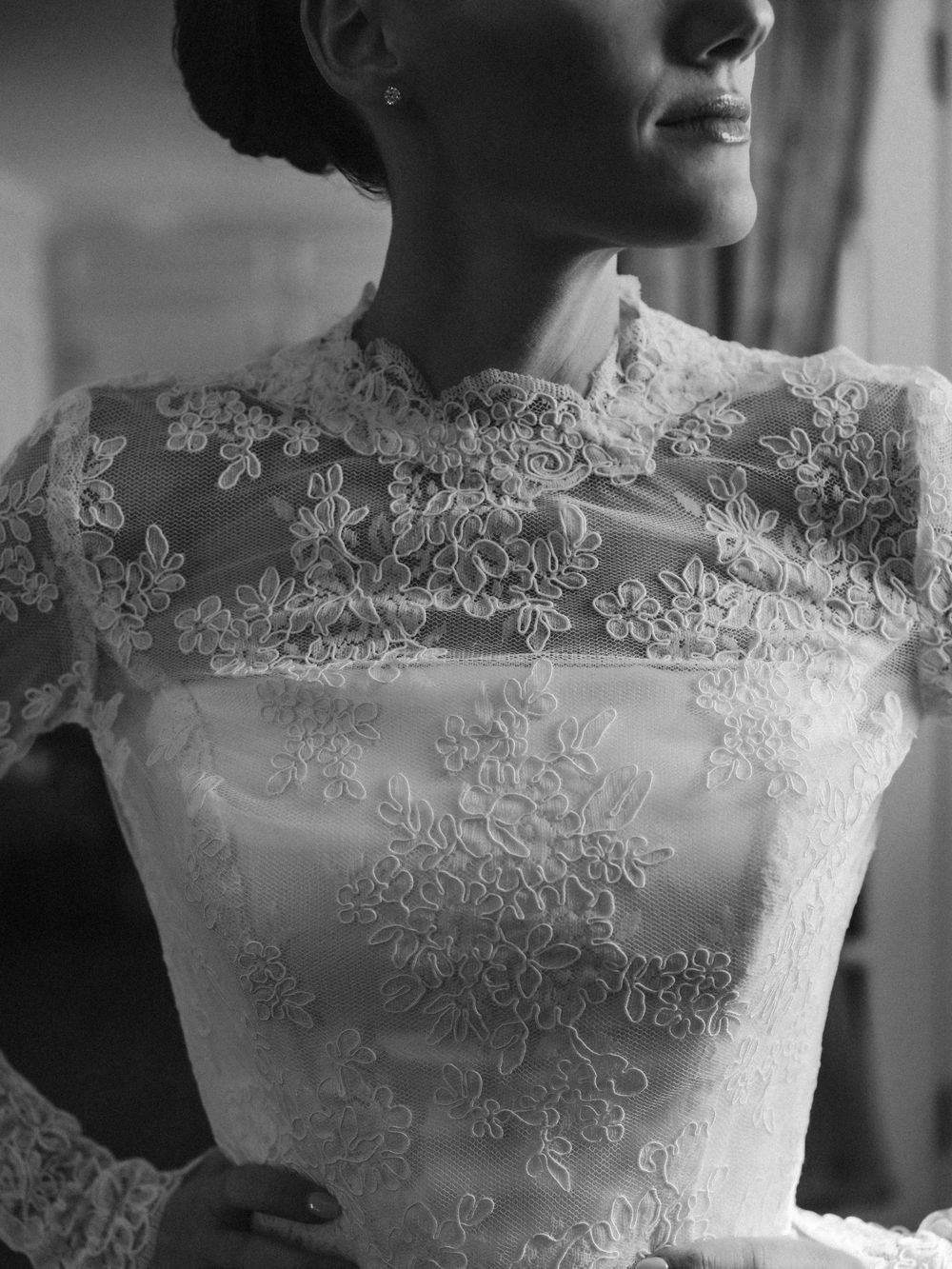 Close-up views of delicate lace details on a white wedding dress bodice in black and white.