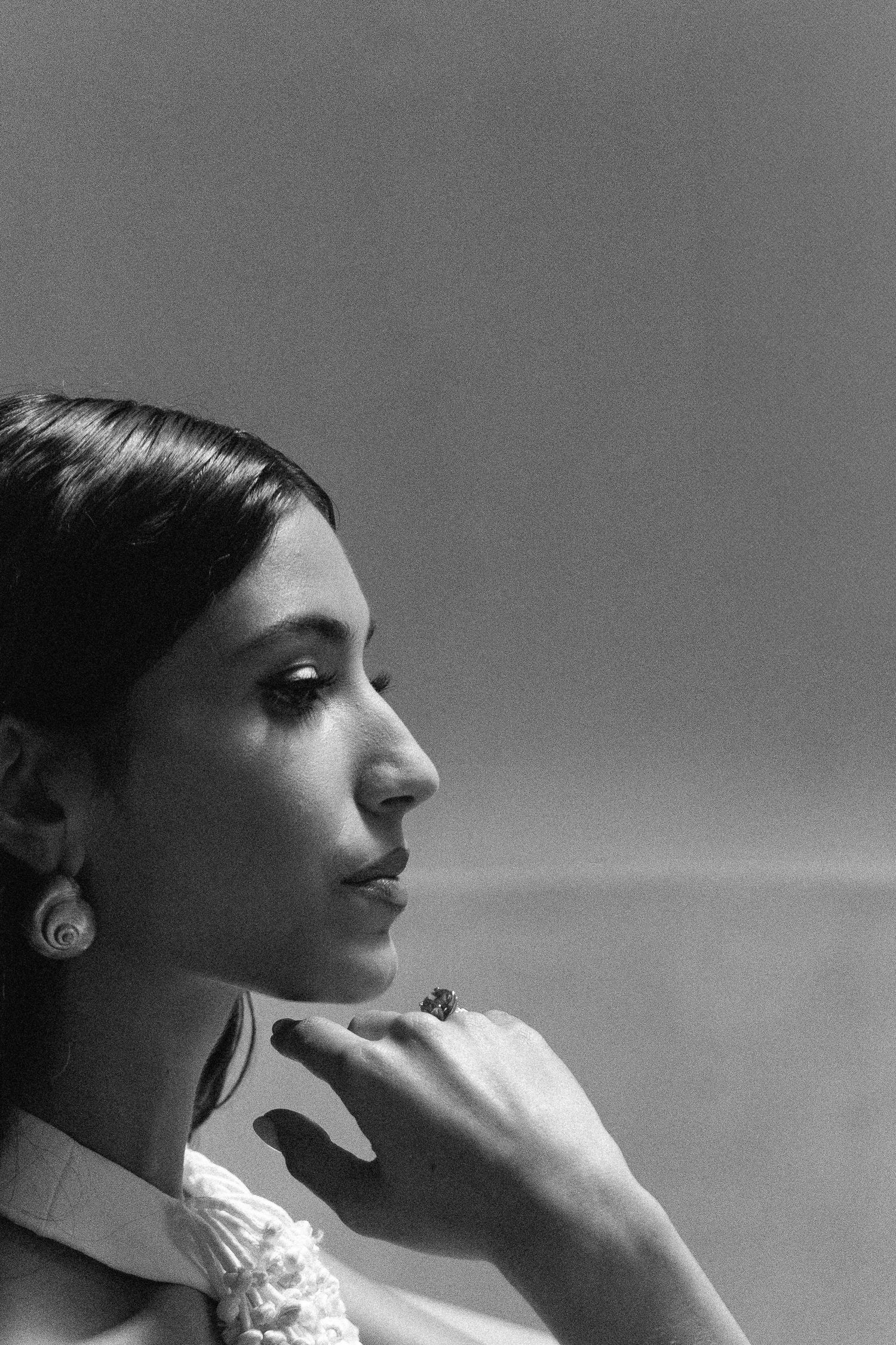 Artistic black and white profile portraits showcasing elegant styling and jewelry.