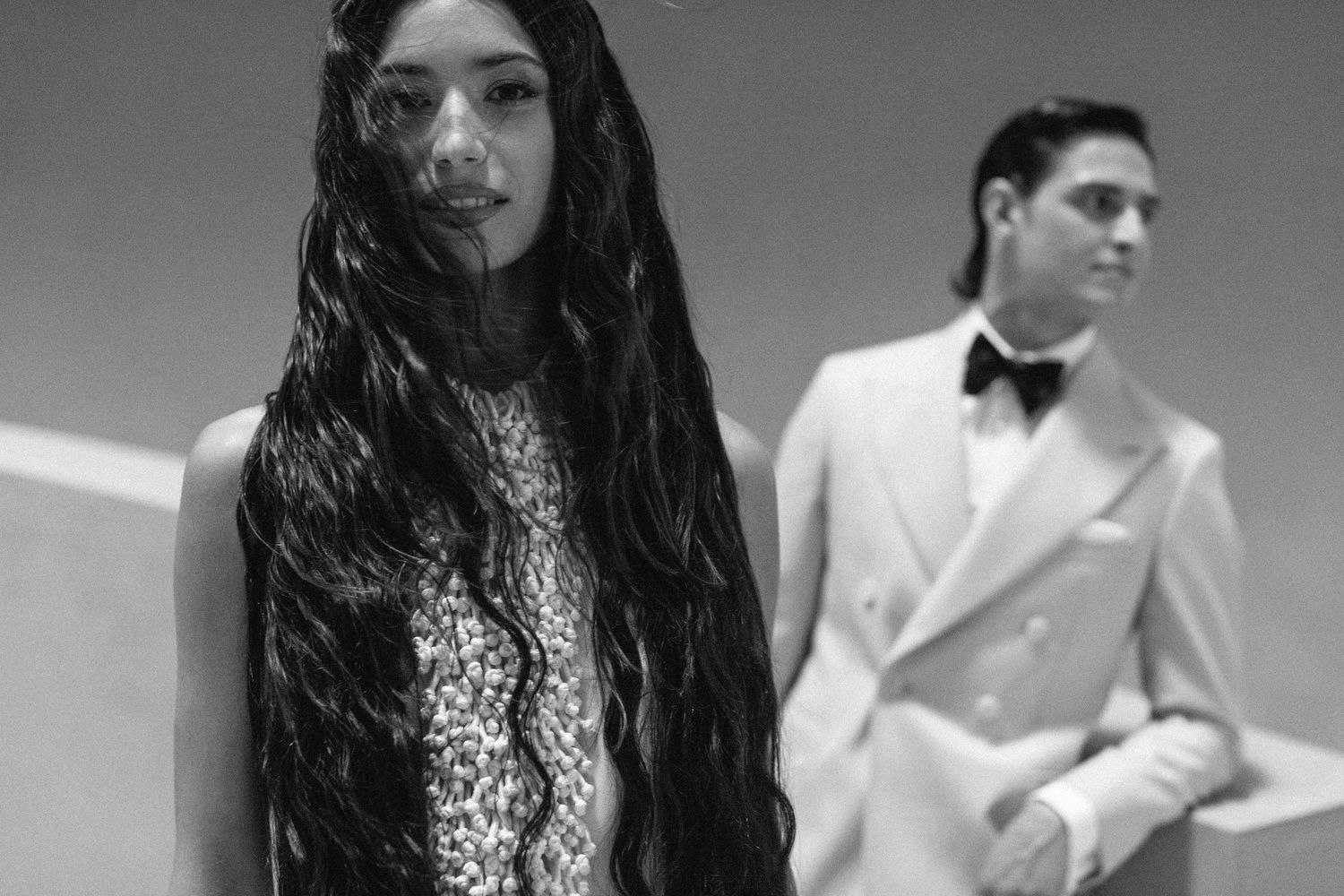 Artistic black and white wedding photography series showing couple in elegant formal wear.