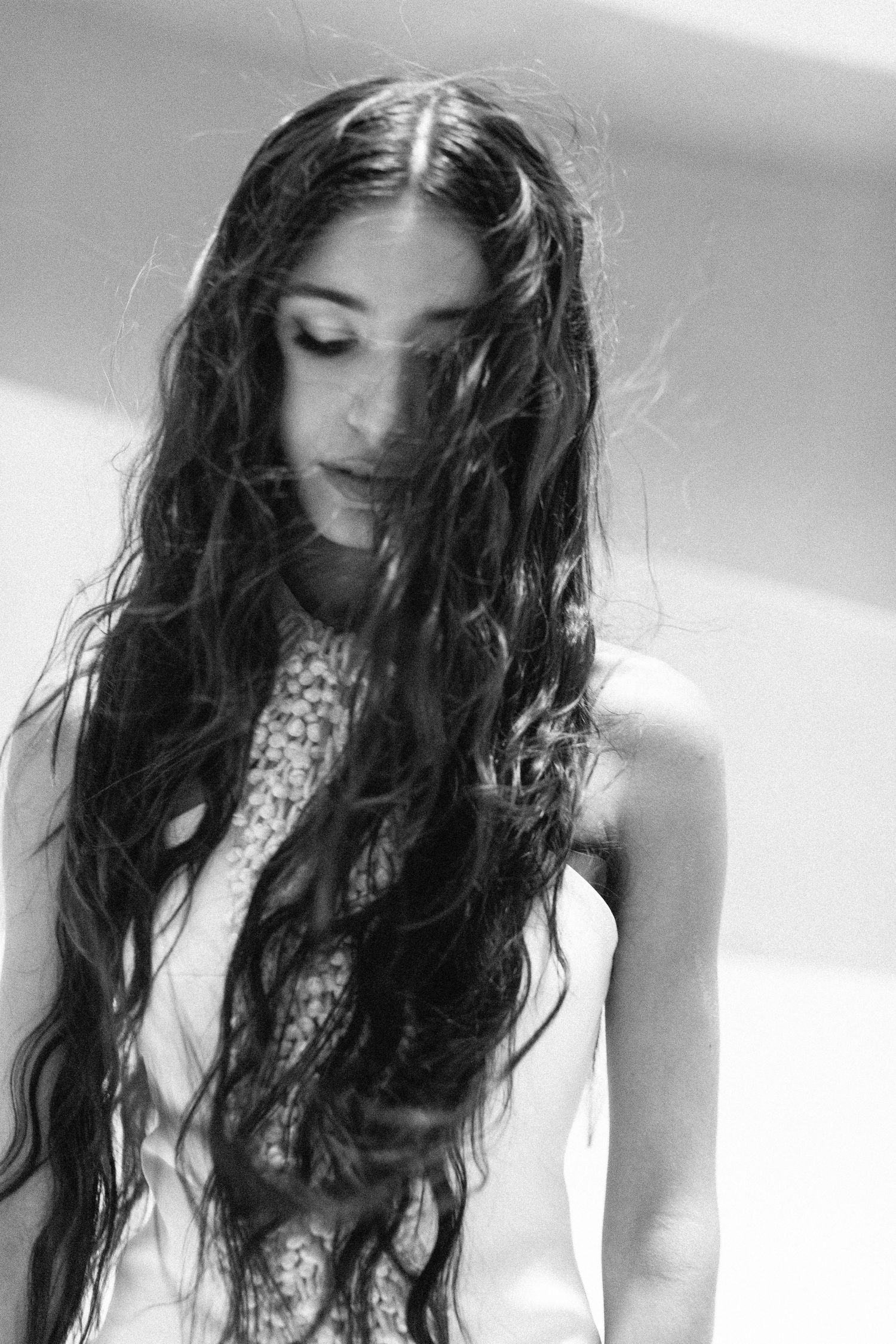 Moody portrait series featuring long dark hair and dramatic lighting.