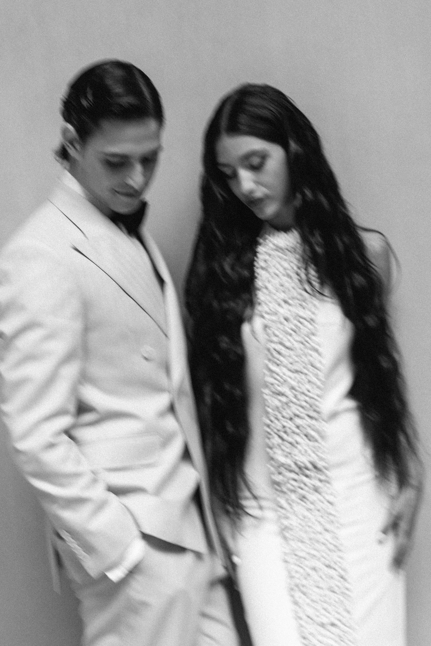 Artistic black and white portraits showing movement and connection between two people.