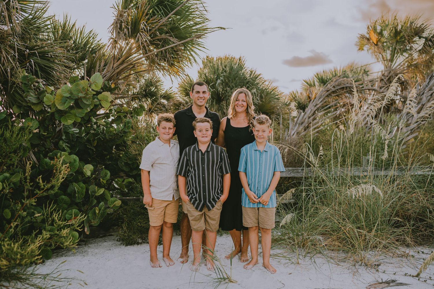 A series of beachside family photos at sunset with palm trees and sand dunes creating a natural coastal backdrop.