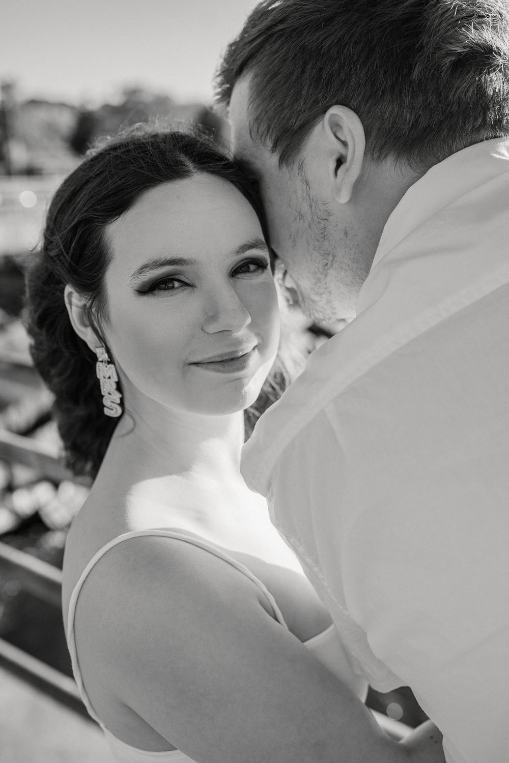 Romantic black and white close-up portraits of a couple embracing during their wedding celebration.