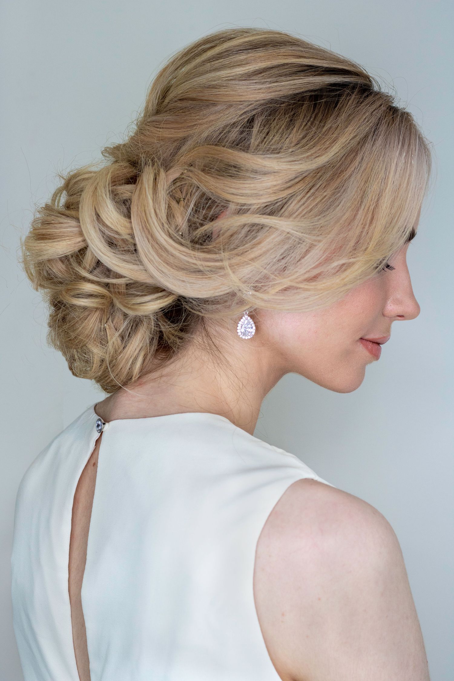 Soft curls forming a low chignon bun