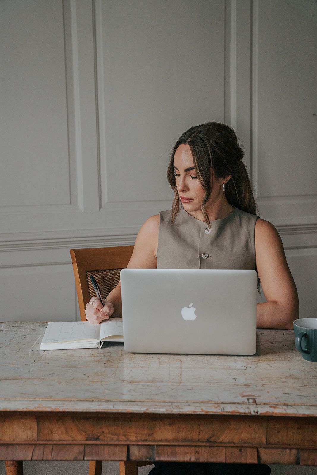 Young business owner branding photo shoot working with laptop and diary