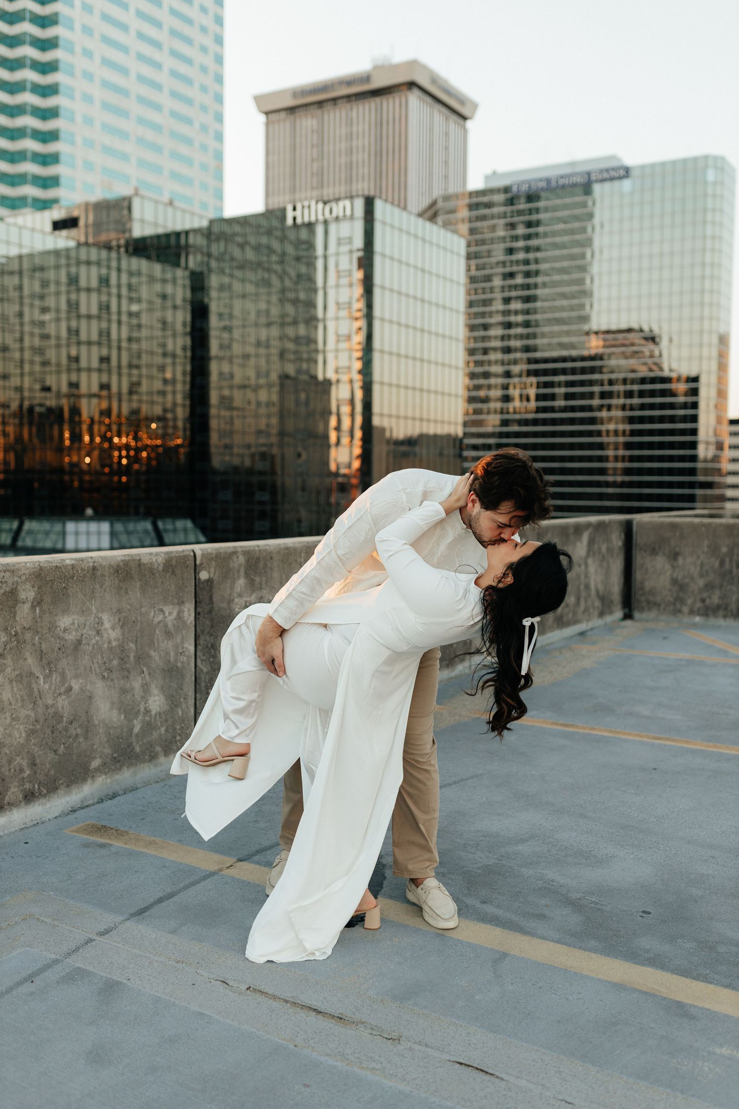 Lifestyle couple portrait captured outdoors in an urban setting with natural light and candid movement.