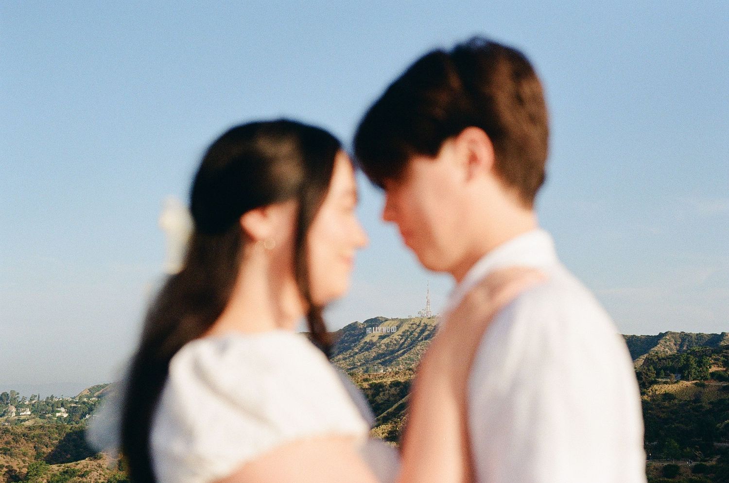 A film photo of a couple with the Hollywood sign behind them from a Los Angeles film Photographer.