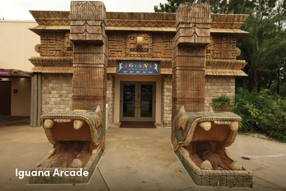Ornate entrance to Iguana Arcade featuring decorative Mayan-inspired architecture and stone carvings.