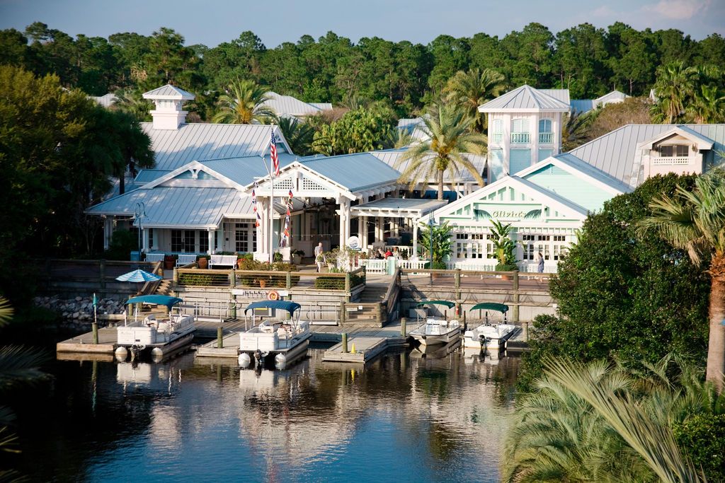 Scenic waterfront view of luxury vacation homes and docks along a tropical waterway.