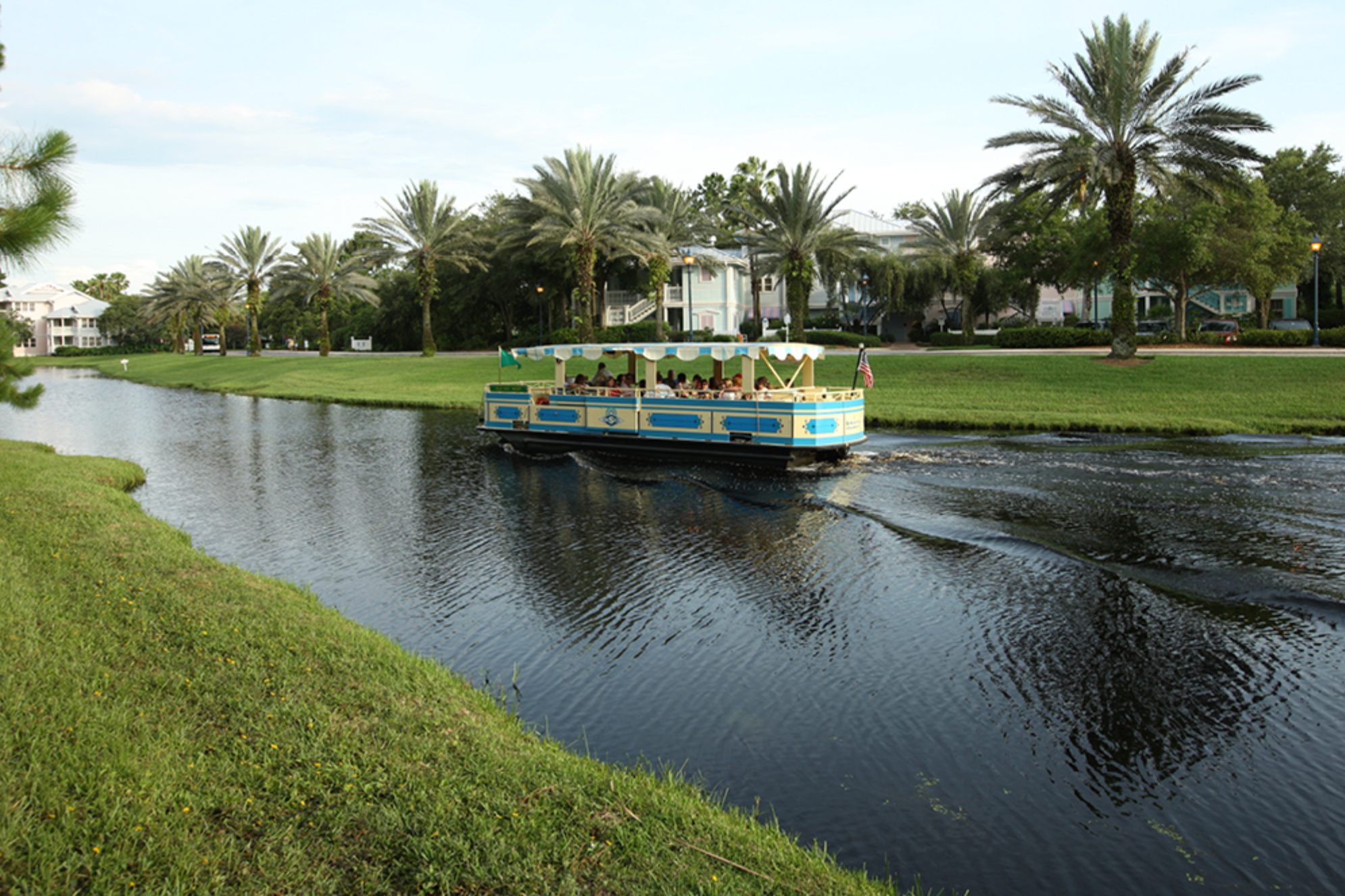 Scenic waterway with tropical landscaping and leisure boats at a resort property.