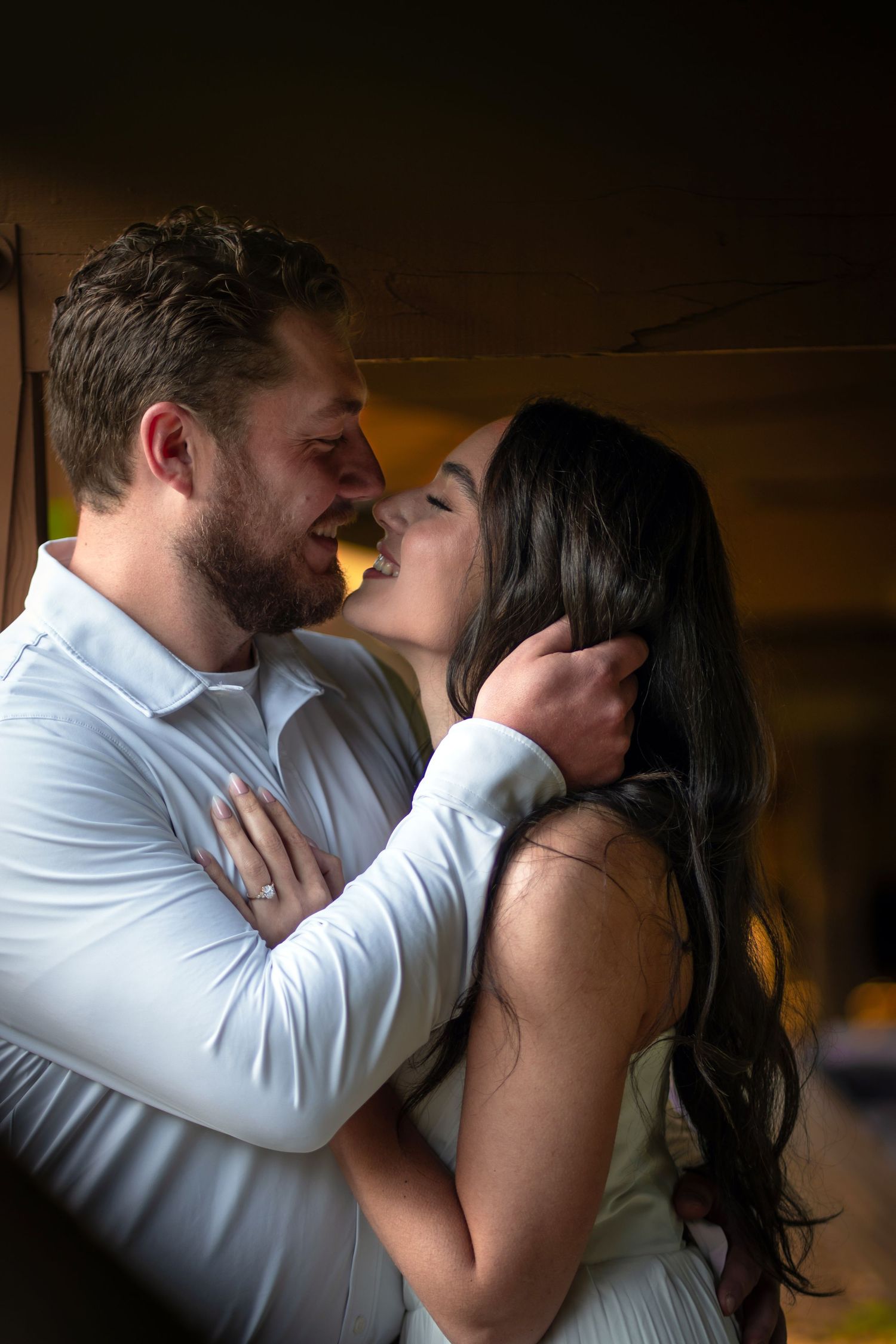 A couple shares a romantic embrace, at Franklin Park