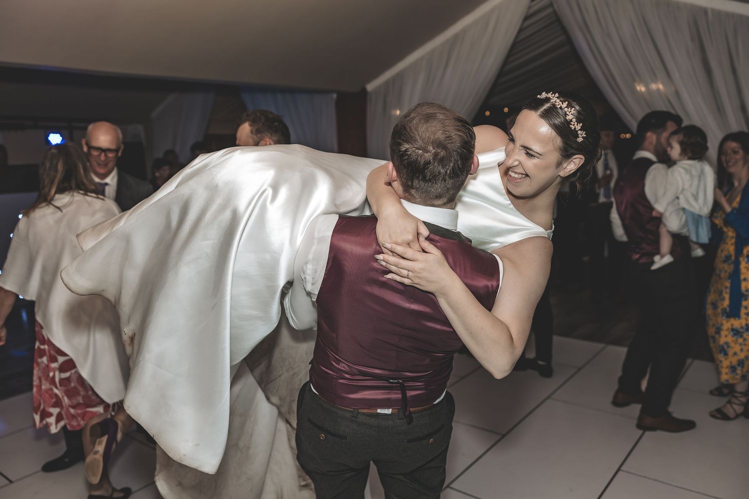 Natural genuine dance floor moment between bride and groom.