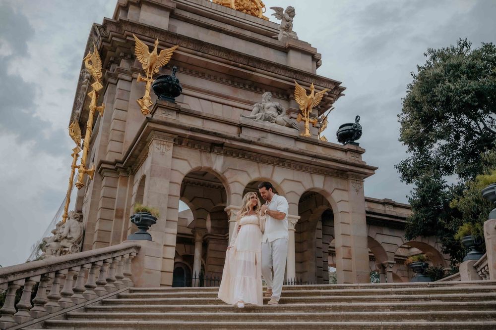 Stylish couple from Dubai posing in front of Cascada Monumental fountain Barcelona.
