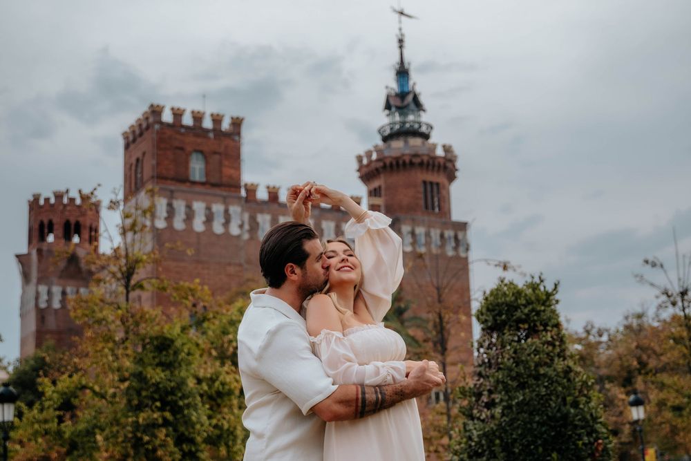 Candid laughter between husband and wife expecting first baby natural couples photoshoot Barcelona.