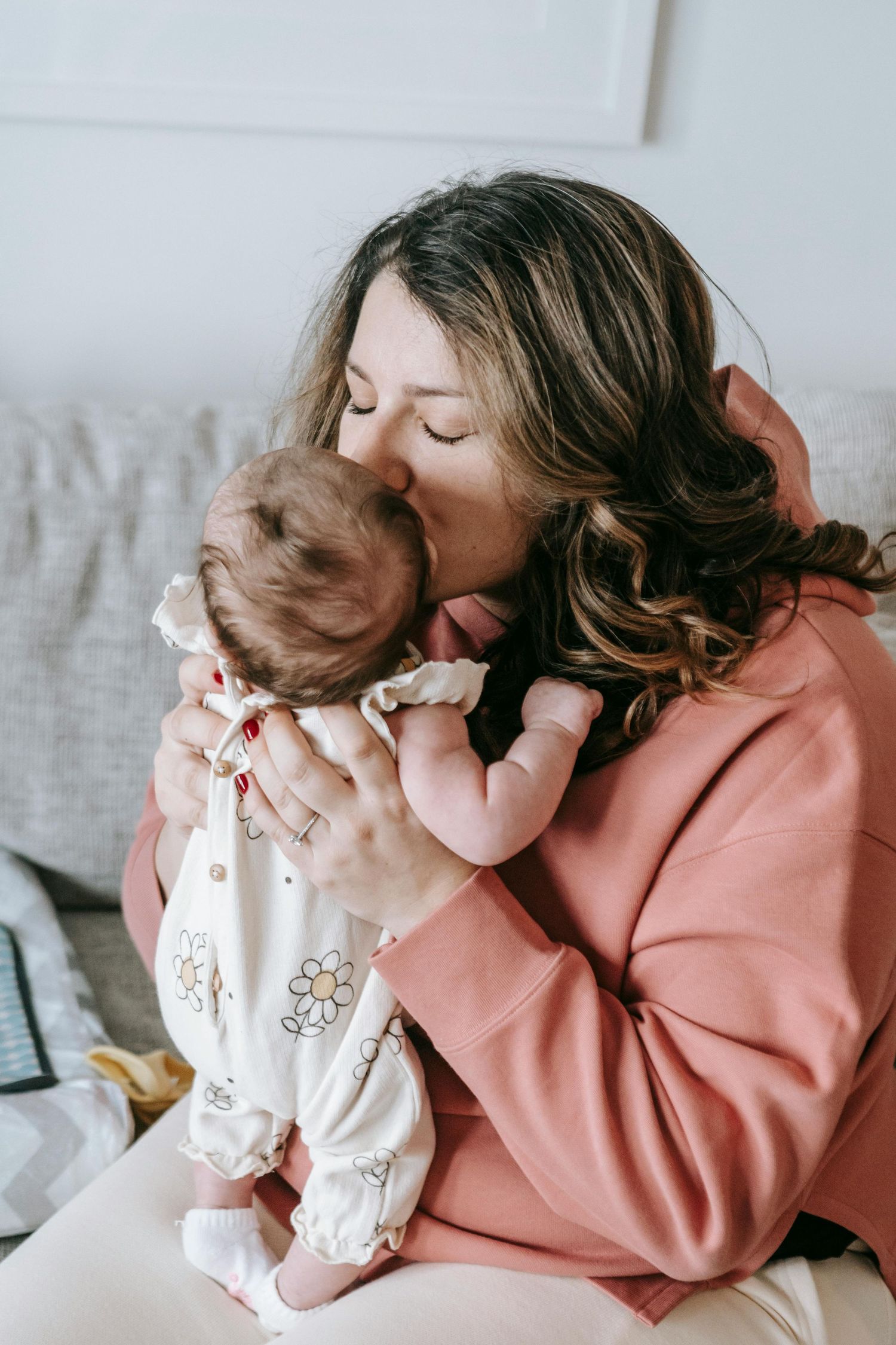 A tender moment shared between mother and baby as they cuddle together, during in-home newborn photos Houston.