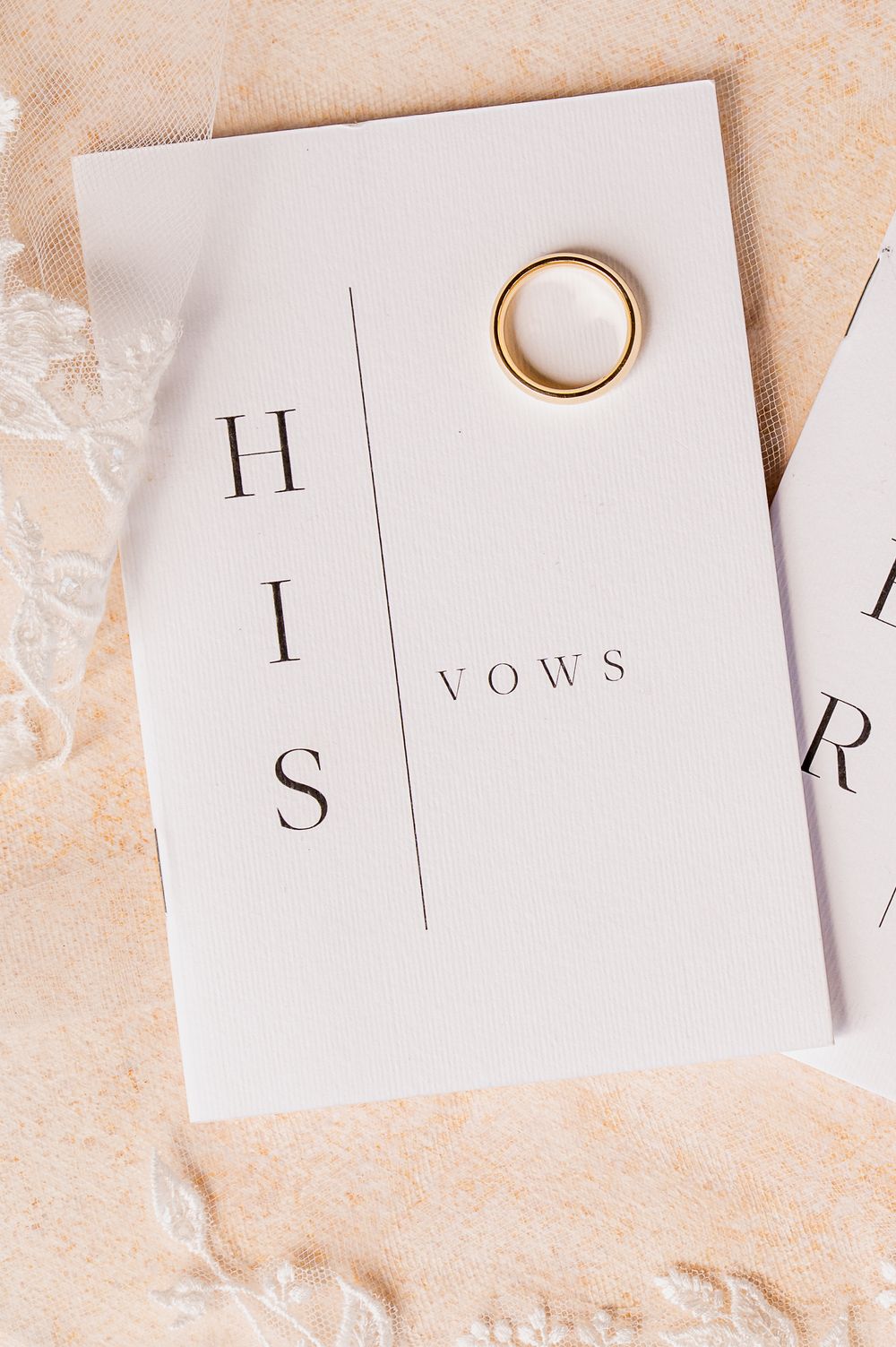 Minimalist wedding vows card with gold ring on beige background.