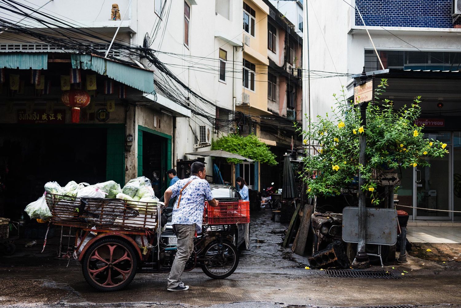 A collection of narrow alleyways and side streets in an Asian city with traditional architecture and power lines overhead.