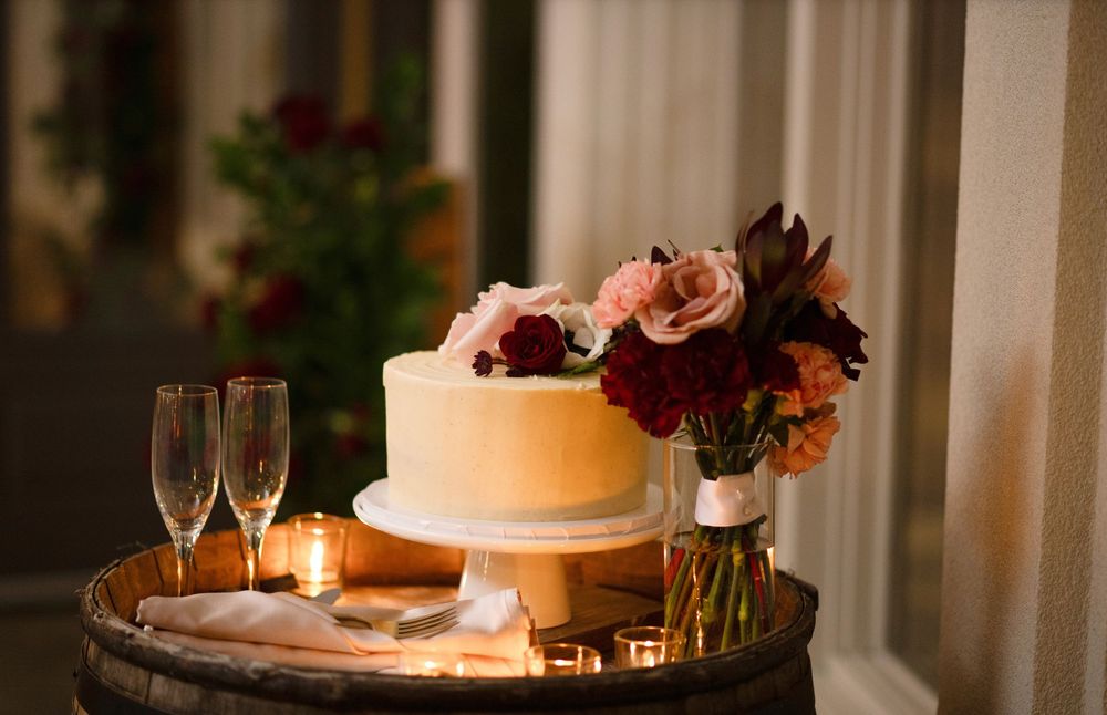 A romantic wedding reception table setting with candlelight, champagne glasses and floral arrangements.