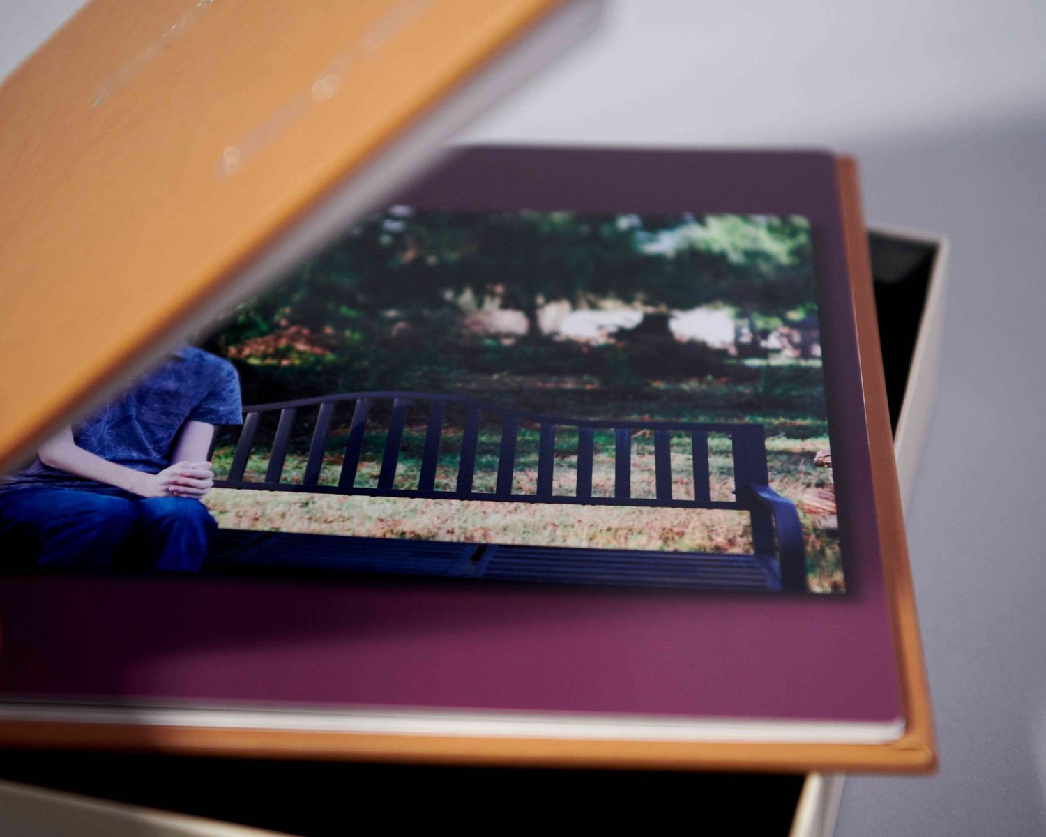 High school "Memory" album in leatherette with cover slightly open.  Detail shows part of senior male photo inside and background color.