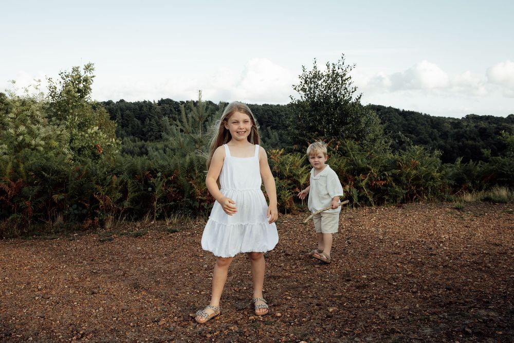 Natural moment of a young brother and sister during a golden hour photo shoot.