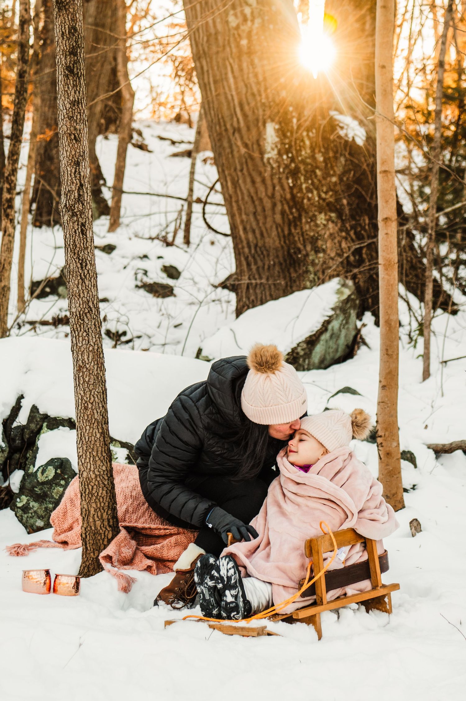 Winter photography series in snowy forest with wooden sled at golden sunset.