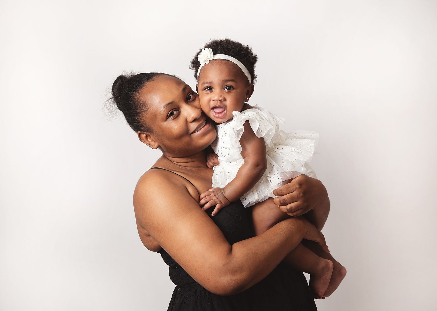 A loving parent shares tender moments with their baby in a series of black and white photographs. During a photoshoot in Bexley