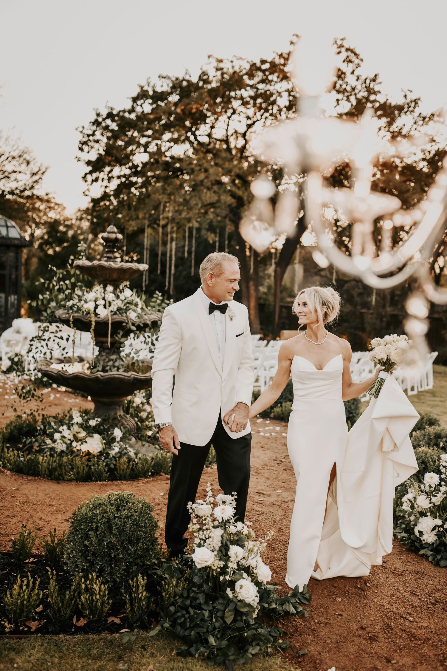 Bride and groom walking at sunset in a candid, romantic wedding moment