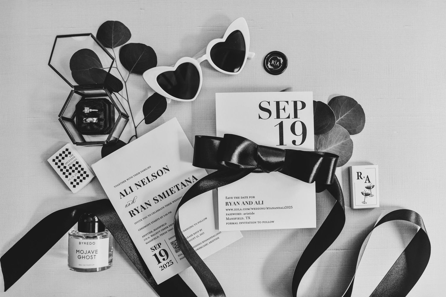 Wedding invitation suite flat lay with rings and bridal details photographed in a clean, editorial style