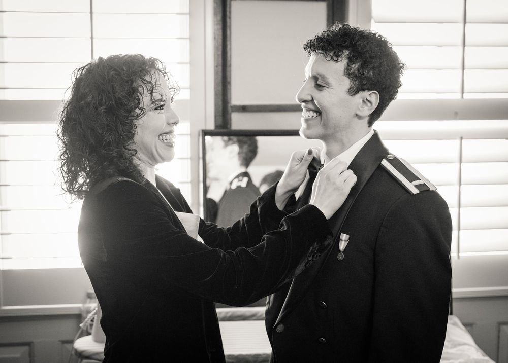 A series of candid black and white photos capturing joyful moments between two people.
