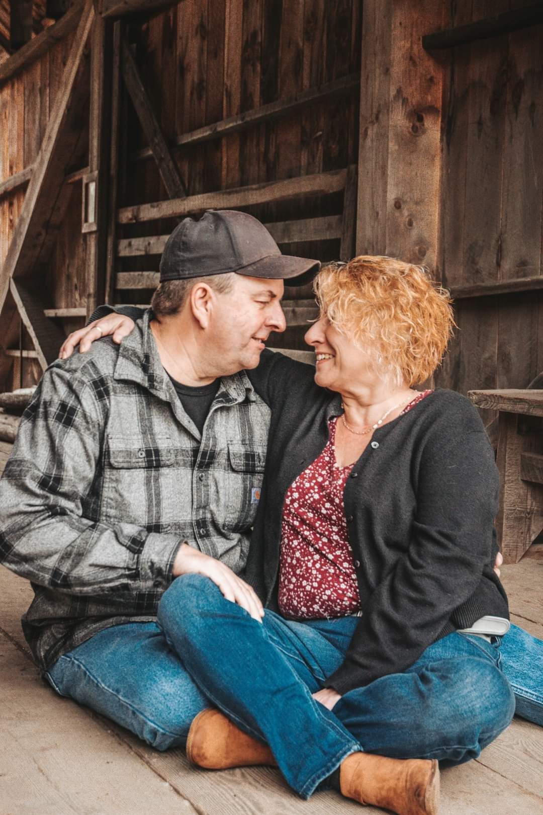 Couple portrait by Northern Exposure featuring a couple looking at each other in a covered bridge.