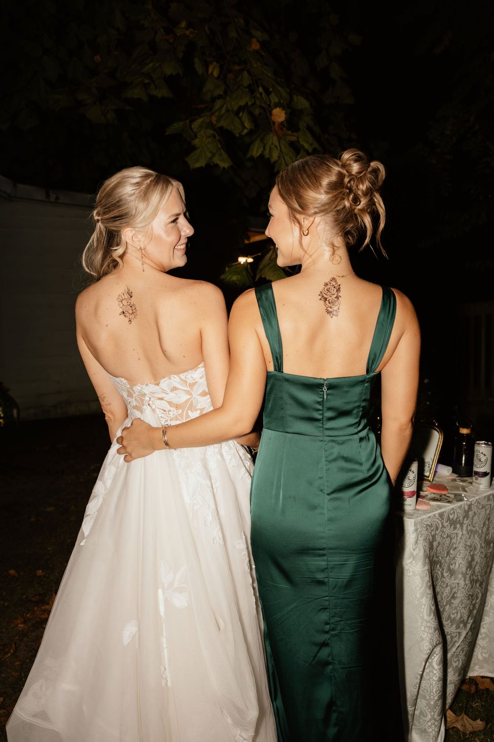 bride and bridesmaid getting tattoo during reception at The Elms of Coosada in Coosada, Alabama